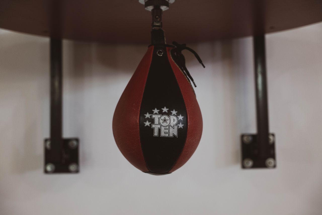 our-story-01 A detailed close-up of a hanging speedbag in a gym, ideal for boxing enthusiasts.
